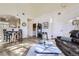 Spacious living area with wood floors, vaulted ceiling, and seamless access to the dining area at 10311 Adams Pl, Thornton, CO 80229