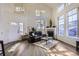 Bright living room featuring a fireplace, vaulted ceilings, lots of natural light, and wood floors at 10311 Adams Pl, Thornton, CO 80229