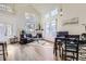 Open-concept living room featuring vaulted ceilings, wood floors, a fireplace, and ample natural light at 10311 Adams Pl, Thornton, CO 80229