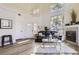 Bright living room featuring a fireplace, vaulted ceilings, lots of natural light, and wood floors at 10311 Adams Pl, Thornton, CO 80229