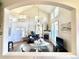 The sun-filled living room features high ceilings, large windows, modern lighting, and luxury vinyl plank flooring at 10311 Adams Pl, Thornton, CO 80229