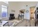 Bright living room with vaulted ceilings, hardwood floors, and an adjacent dining area at 10311 Adams Pl, Thornton, CO 80229