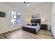 The main bedroom has luxury vinyl plank flooring and lots of natural light from the oversized window at 10311 Adams Pl, Thornton, CO 80229