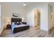 The spacious main bedroom has high ceilings, luxury vinyl plank flooring, and an ensuite bathroom at 10311 Adams Pl, Thornton, CO 80229