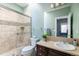 Bright bathroom featuring a glass shower, neutral tile, and a coordinating vanity at 2800 Aurora Ave # 121, Boulder, CO 80303