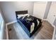 Bedroom featuring a small bed and white closet doors at 2800 Aurora Ave # 121, Boulder, CO 80303