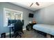 Bedroom with a large window, ceiling fan, and wall-mounted TV above a small dresser at 2800 Aurora Ave # 121, Boulder, CO 80303