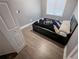 Cozy bedroom with wood-look floors and a twin bed by a window at 2800 Aurora Ave # 121, Boulder, CO 80303