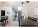 Open concept dining room with staircase and breakfast bar views to the kitchen at 2800 Aurora Ave # 121, Boulder, CO 80303