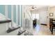 Inviting entryway with tiled floor and staircase with white railing leading to the upper level at 2800 Aurora Ave # 121, Boulder, CO 80303