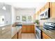 Well-lit kitchen with stainless steel appliances and views of the outdoors at 2800 Aurora Ave # 121, Boulder, CO 80303