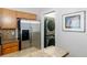 Laundry area adjacent to the kitchen with stainless steel appliances at 2800 Aurora Ave # 121, Boulder, CO 80303