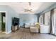 Spacious living room with modern decor, ceiling fan, and doors leading to the outside at 2800 Aurora Ave # 121, Boulder, CO 80303