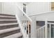 Carpeted staircase with white railings leading to the upper level of the house at 2800 Aurora Ave # 121, Boulder, CO 80303
