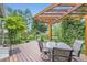 Relaxing deck with a wooden pergola, complemented by green landscaping and natural light at 284 S Lincoln Ave, Louisville, CO 80027