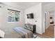 Spacious bedroom with a bed, a dresser, and access to a hallway and bathroom at 2121 Hummingbird Way # 204, Georgetown, CO 80444
