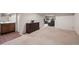 Spacious finished basement featuring neutral carpet, a kitchenette with sink and cabinet space, and comfortable seating area at 6848 Zenobia St # 9, Westminster, CO 80030
