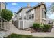 Inviting condo exterior boasts stone accents, gray siding, and well-maintained landscaping at 6848 Zenobia St # 9, Westminster, CO 80030