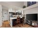Charming kitchen features stainless appliances, a breakfast bar, and hardwood floors at 6848 Zenobia St # 9, Westminster, CO 80030