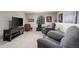 Finished basement Gathering room area with comfortable seating, television, and neutral carpet at 6848 Zenobia St # 9, Westminster, CO 80030