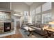 Spacious living room with a stone fireplace, vaulted ceiling, and abundant natural light at 6848 Zenobia St # 9, Westminster, CO 80030