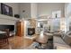 Bright living room featuring a stone fireplace, vaulted ceiling, and hardwood floors at 6848 Zenobia St # 9, Westminster, CO 80030