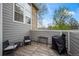 Exterior patio area with grill, chairs, and views of the yard and surrounding greenery at 6848 Zenobia St # 9, Westminster, CO 80030