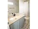 Updated bathroom featuring a new vanity with stone countertop, modern fixtures, and tiled shower with tub at 5151 Jasper St, Denver, CO 80239