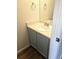 Powder room offers a single vanity with light countertops and framed mirror above at 5151 Jasper St, Denver, CO 80239