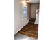 Welcoming entryway with hardwood flooring and a staircase leading to the upper level at 5151 Jasper St, Denver, CO 80239