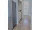 Hallway including stainless steel refrigerator, washer and dryer, and a stairway to the next level at 5151 Jasper St, Denver, CO 80239