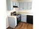 Kitchen featuring black appliances, light blue cabinets, and light countertops at 5151 Jasper St, Denver, CO 80239