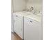 Laundry Area includes white washer and dryer with metal knobs and white walls at 5151 Jasper St, Denver, CO 80239