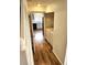 Hallway view including the laundry room, hard flooring, and kitchen beyond at 5151 Jasper St, Denver, CO 80239