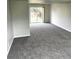 Spacious living room with neutral carpet and sliding doors leading to the backyard at 5151 Jasper St, Denver, CO 80239