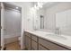Bathroom with double sink vanity, white countertops, and a tiled shower and tub at 1400 Colony Dr, Erie, CO 80026