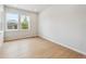 Bright bedroom featuring hardwood floors and natural light from the large windows at 1400 Colony Dr, Erie, CO 80026