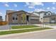 Charming one-story home with stone accents, an attached garage, and green lawn at 1400 Colony Dr, Erie, CO 80026