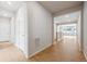Bright hallway with hardwood floors leading to various rooms in the house at 1400 Colony Dr, Erie, CO 80026