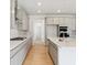 Modern kitchen with gray cabinets, quartz countertops, and stainless steel appliances at 1400 Colony Dr, Erie, CO 80026
