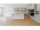 Open concept kitchen with stainless steel appliances, center island, and sleek gray cabinets at 1400 Colony Dr, Erie, CO 80026