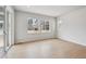 Bright living room featuring light hardwood flooring and large windows, creating an airy space at 1400 Colony Dr, Erie, CO 80026