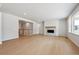 Open-concept living room with fireplace, hardwood floors, and lots of windows providing natural light at 1400 Colony Dr, Erie, CO 80026