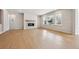 Spacious living room with fireplace, hardwood floor, large windows for natural light, and ample space at 1400 Colony Dr, Erie, CO 80026