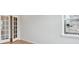 Room featuring hardwood floors, natural light, and double doors at 1400 Colony Dr, Erie, CO 80026