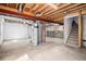 Spacious unfinished basement featuring exposed ceiling, concrete floor, and stairs to upper level at 5479 Lost Meadow Trl, Castle Rock, CO 80104