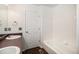 Bright bathroom with white tiled walls, dark wood flooring, and a modern vanity at 5479 Lost Meadow Trl, Castle Rock, CO 80104