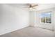 Bedroom featuring carpet flooring, a ceiling fan, and a large window at 5479 Lost Meadow Trl, Castle Rock, CO 80104