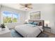 This bedroom features a ceiling fan and an exterior view out of a large window at 5479 Lost Meadow Trl, Castle Rock, CO 80104