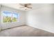 Bedroom featuring a large window, carpet flooring, and a ceiling fan at 5479 Lost Meadow Trl, Castle Rock, CO 80104